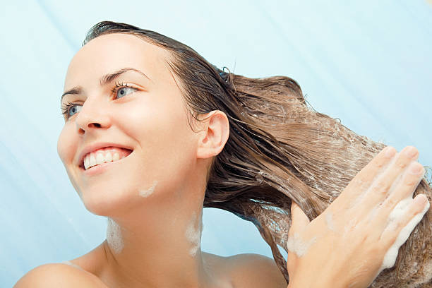 shampoo time! - woman washing hair stockfoto's en -beelden