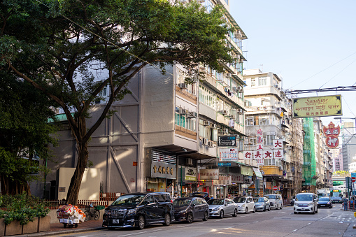 Hong Kong - October 4, 2021 : Residential building and shops at the Shanghai Street in Yau Ma Tei, Kowloon, Hong Kong.