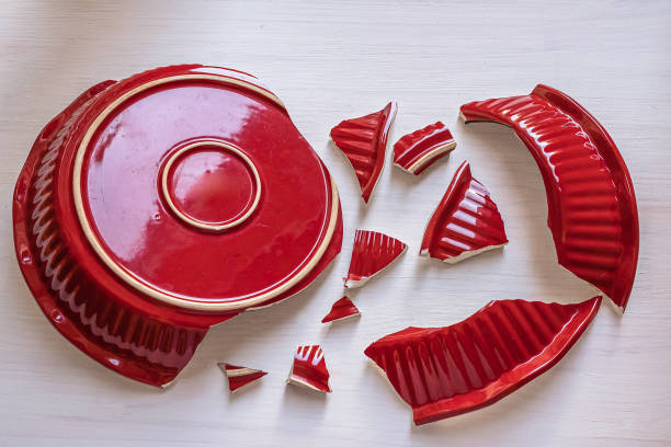 shards of a red ceramic plate - breekbaar bord stockfoto's en -beelden