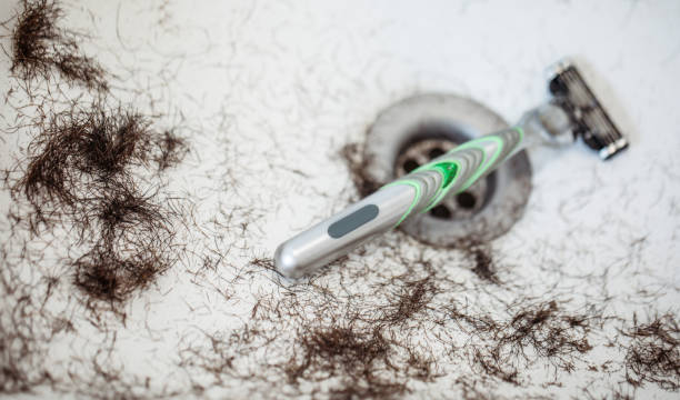 Shaved hairs in the washbasin with razor and trimmer. Hairdresser tools Shaved hairs in the washbasin with razor and trimmer. Hairdresser tools macro body hair stock pictures, royalty-free photos & images