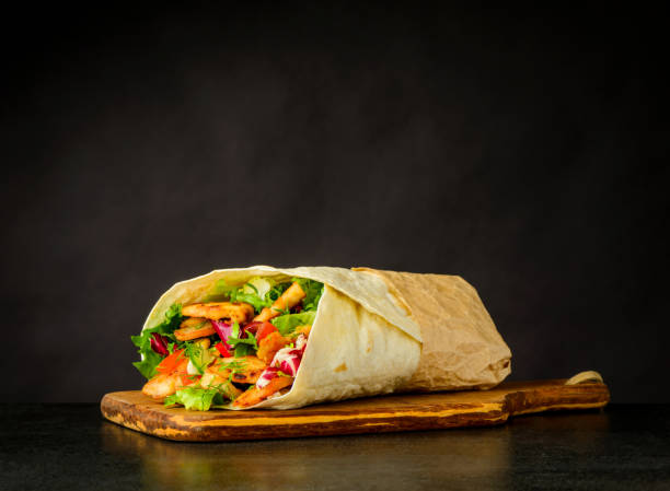 Shawarma Sandwich on Dark Background Shawarma Turkish Sandwich with Meat and Vegetables on Dark Background shawarma stock pictures, royalty-free photos & images