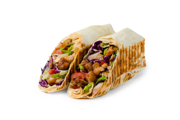 shawarma with chicken, lettuce and tomato cut on a white background shawarma with chicken, lettuce and tomato cut on a white background. High quality photo shawarma stock pictures, royalty-free photos & images