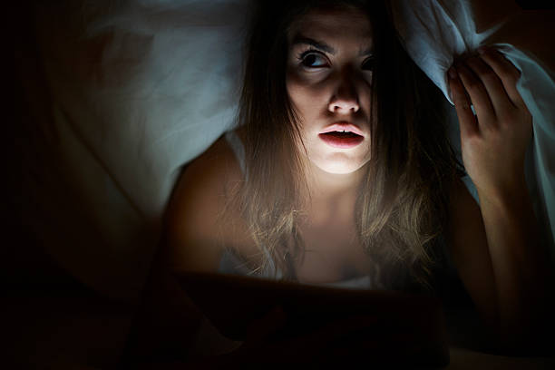 She watching scary movie being alone at home She watching scary movie being alone at home duvet photos stock pictures, royalty-free photos & images