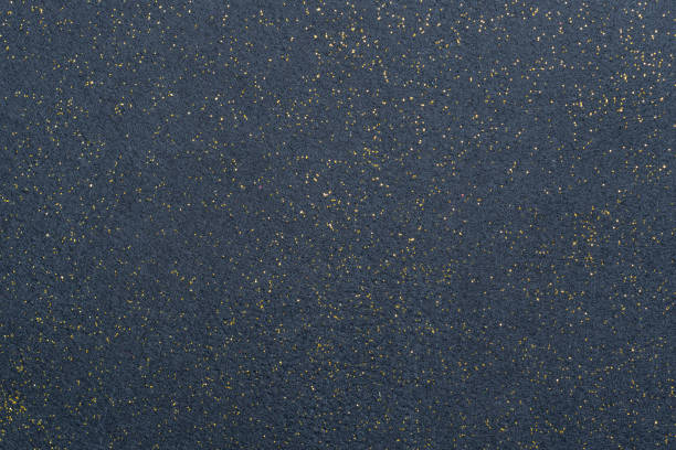 A sheet of navy blue decorative interlining with golden glitter dots. Non-woven fabric as a background. Star galaxy universe concept stock photo