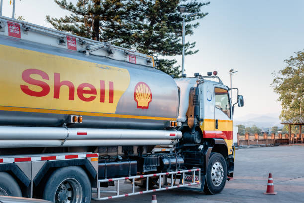 Shell Gas Station and Trailer Truck During Sunset. Royal Dutch Shell Oil and Gas Industry Production, Refining, Transport, Marketing, Petrochemical and Trading. stock photo