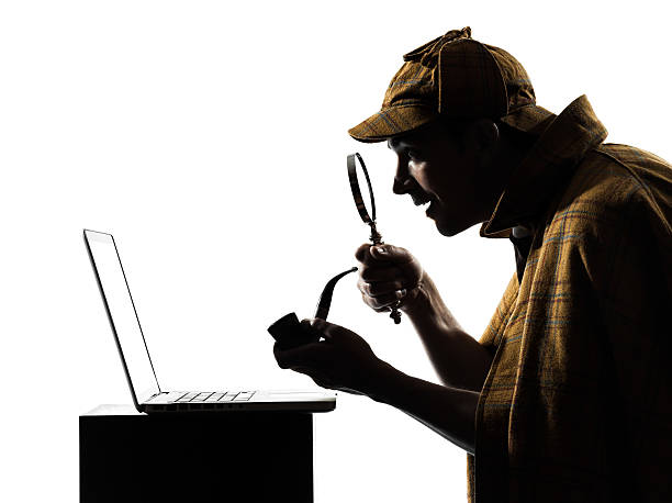 Sherlock Holmes using a laptop sherlock holmes silhouette in studio on white background sherlock holmes stock pictures, royalty-free photos & images