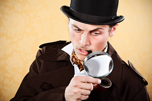 Sherlock Holmes with hat, trenchcoat, and magnifying glass Man dressed up as famous detective Sherlock Holmes sherlock holmes stock pictures, royalty-free photos & images