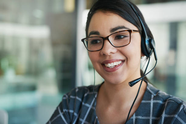 She’s a delight to speak to Shot of a happy young woman using a headset at work headset woman customer service stock pictures, royalty-free photos & images