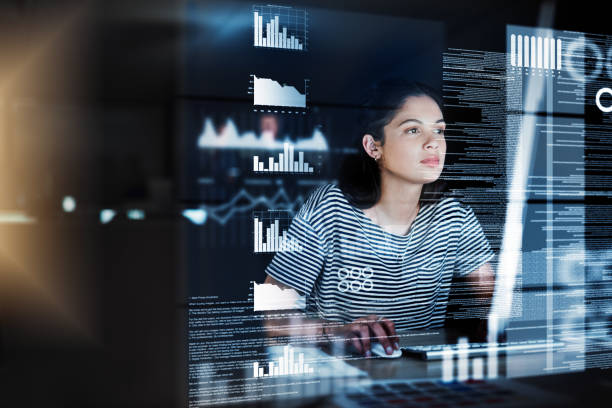 She's focused on cracking it Shot of a programmer working on a computer code at night Software Developer stock pictures, royalty-free photos & images