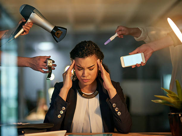 She's got too many demands and distractions to deal with Cropped shot of a stressed out businesswoman working late in an office distractions stock pictures, royalty-free photos & images