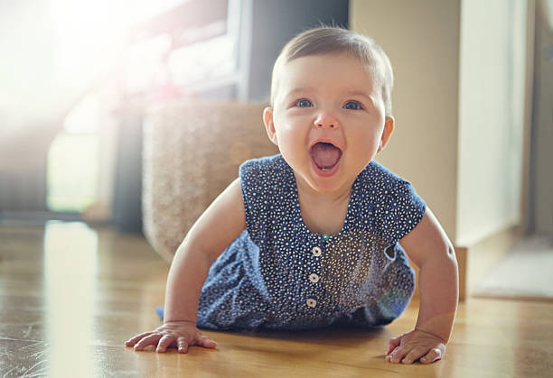 She's on the move Shot of an adorable baby crawling on the living room floorhttp://195.154.178.81/DATA/i_collage/pu/shoots/805468.jpg crawling stock pictures, royalty-free photos & images