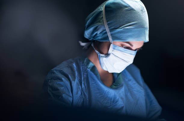 She's one of the most notable in her profession Shot of a surgeon in an operating theatre surgeon stock pictures, royalty-free photos & images
