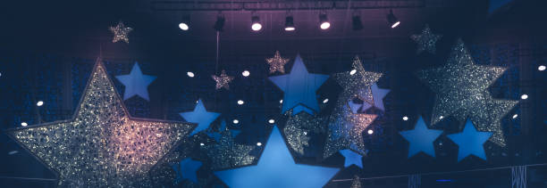 shining stars shape night  spotlights soffits show stage performance vintage background with gradient dark blue pink lilac purple lights stock photo