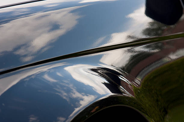 Shiny close-up of a vehicle which is reflecting the sky Effect before and after polishing lacquered stock pictures, royalty-free photos & images