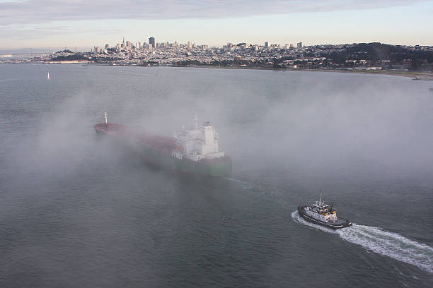 Ship and Tug Boat Pass Under the Golden Gate Bridge stock photo