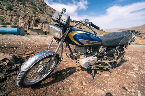 Shiraz, Iran - 04.09.2019: An old motocycle in a nomad camp near Shiraz, Fars province, Iran, Persia.