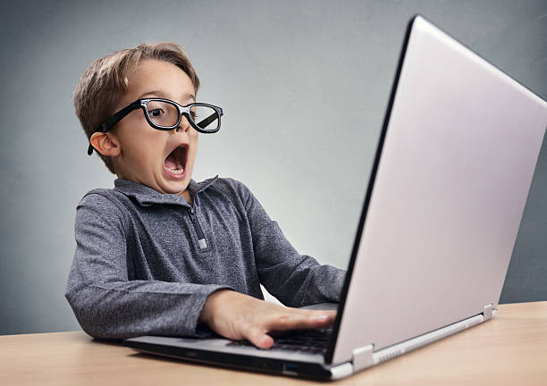 shocked and surprised boy on the internet with laptop computer - chock bildbanksfoton och bilder