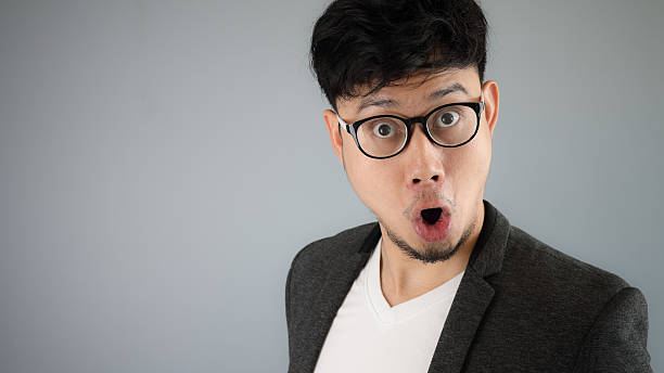 Shocked Asian businessman with glasses. stock photo