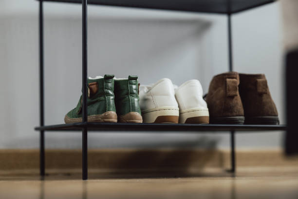 Shoe Rack with Family Shoes at Home stock photo