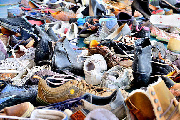 Shoes, lots of used in pile stock photo