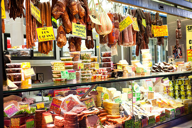 Shop front at the Queen Victoria Markets, Melbourne, Australia Melbourne, Australia - April 8, 2011: Shop front displaying various deli meats, olives and condiments at the Queen Victoria Markets, a famous landmark in Melbourne, Australia queen victoria market stock pictures, royalty-free photos & images