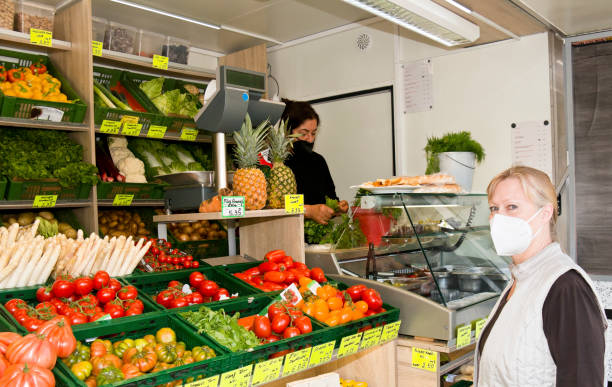 Shopping at a fruit and vegetable stand during pandemic stock photo