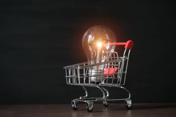 Shopping cart with light bulb. stock photo