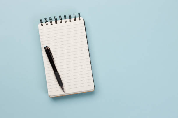 Shopping list - Concept Spiral notebook and pen on blue background shopping list stock pictures, royalty-free photos & images
