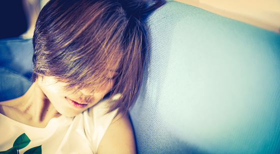 Short Hair Japanese Teenager Sleeping On Sofa Stock Photo
