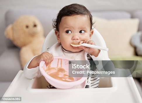 istock Shot of a baby eating a meal at home 1365606385