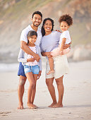 istock Shot of a beautiful young family of three spending the day together at the beach 1369333670