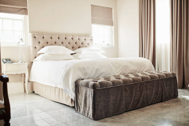 Shot of a bed in a modern hotel room stock photo
