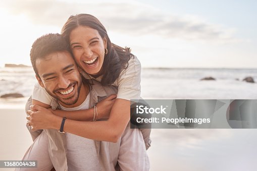 istock Shot of a couple enjoying a day at the beach 1368004438