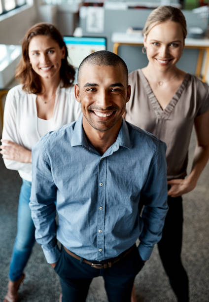 Shot of a diverse group of businesspeople standing together in the office during the day stock photo