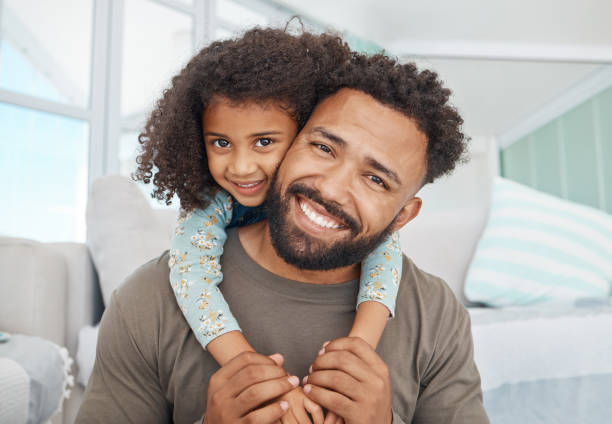 Shot of a father and his little daughter relaxing together at home stock photo