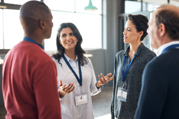 Shot of a group of businesspeople networking at a conference stock photo