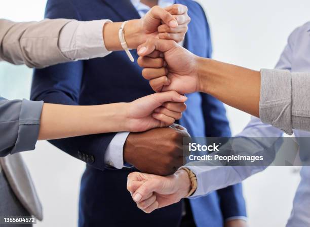 Shot of a group of unrecognizable businesspeople stacking their hands on top of each other