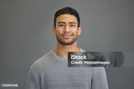 istock Shot of a handsome young man standing against a grey background 1335941248