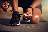 istock Shot of a man tying his laces before running 1332633741