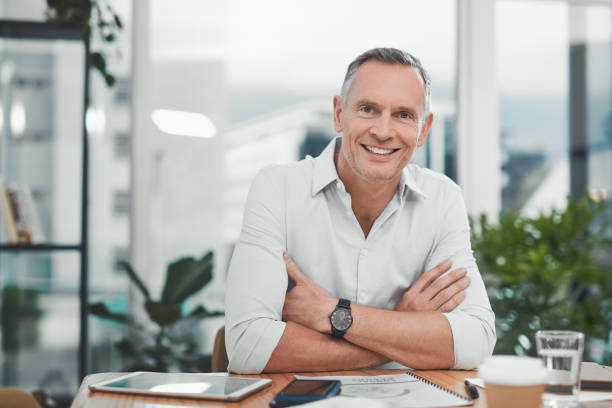 Shot of a mature businessman working at his desk in a modern office stock photo