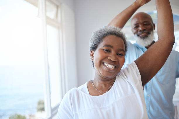 Shot of a mature couple sharing a dance inside stock photo