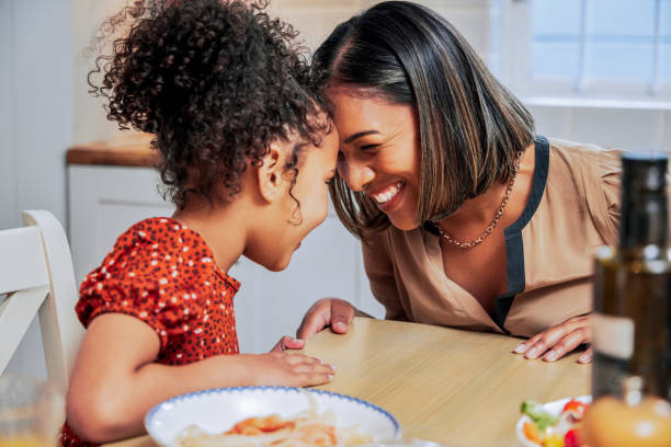 Shot of a mother and daughter bonding over a meal stock photo
