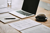 istock Shot of a notebook and laptop in an office 1336695502