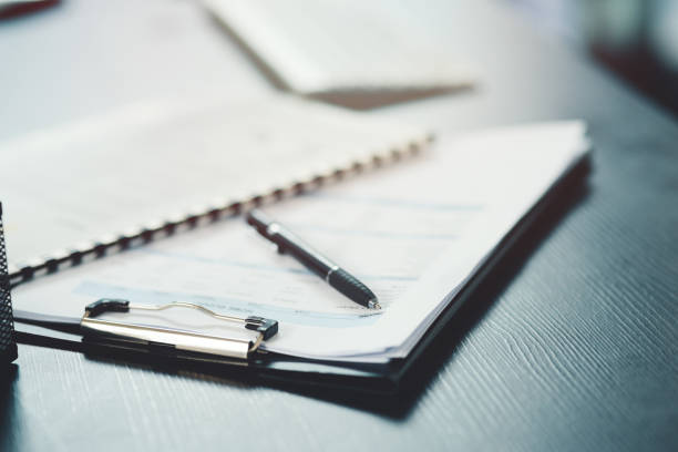 shot of a notebook and pen on a desk in an office - plano documento imagens e fotografias de stock