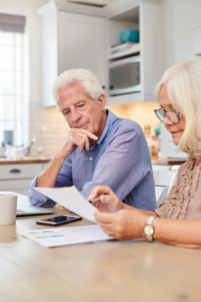 Shot of a senior couple going through paperwork at home stock photo