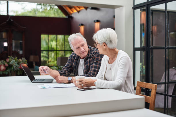 Shot of a senior couple using a laptop at home stock photo