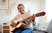 istock Shot of a senior man playing the guitar at home 1385050658