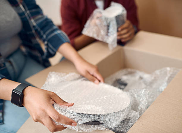 Shot of a young couple unpacking boxes in their new home stock photo
