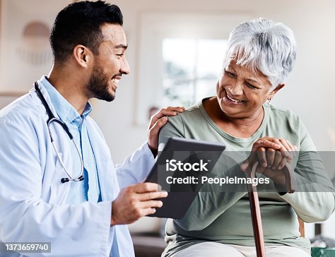 istock Shot of a young doctor sharing information from his digital tablet with an older patient 1373659740