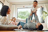 istock Shot of a young family playing together on the lounge floor at home 1366667952